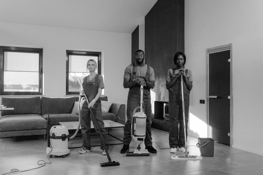 pexels-photo-6195120-6195120 A team of three professional cleaners in uniforms with equipment ready for housekeeping.